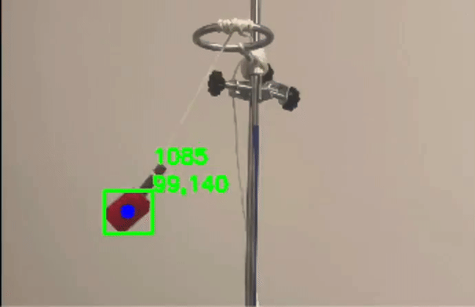 Video of a swinging pendulum with the tracker following the bob and tracing its arc